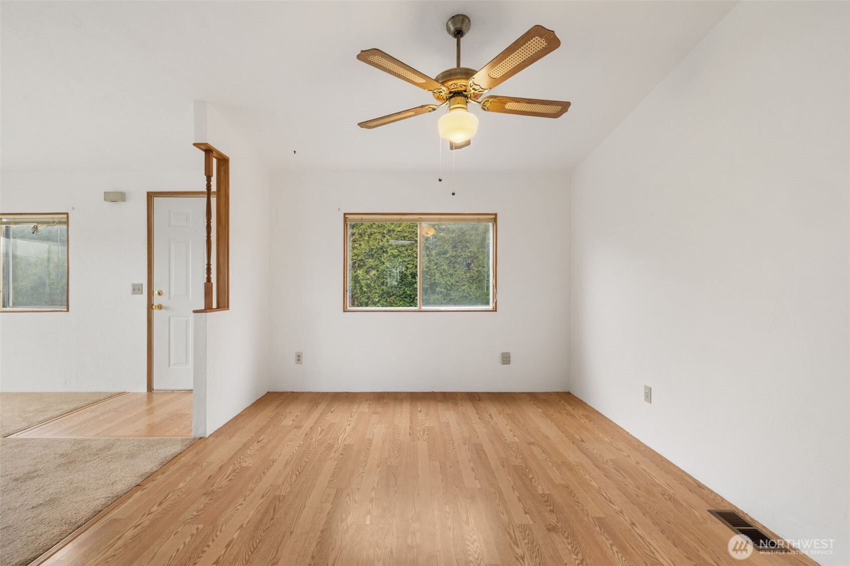 836 Harman Way South, Unit 33 Orting, WA 98360 - Photo 11 of 30 an empty room with wooden floor and windows