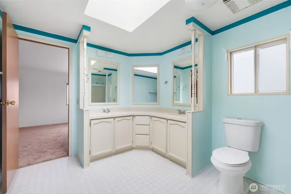 a bathroom with a toilet sink and a mirror