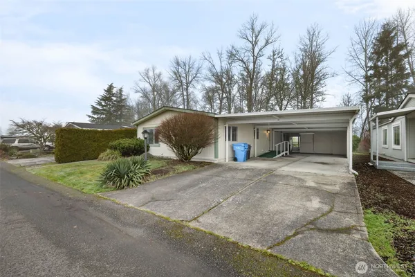 a view of a house with a yard and garage