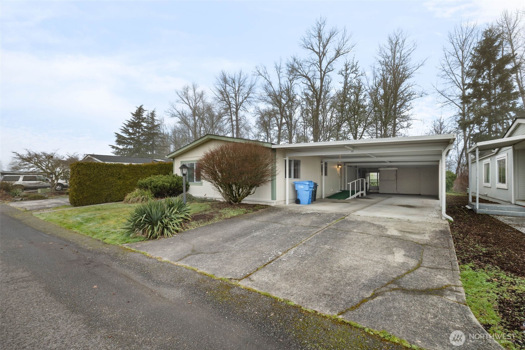 836 Harman Way South, Unit 33 Orting, WA 98360 - Photo 2 of 30 a view of a house with a yard and garage