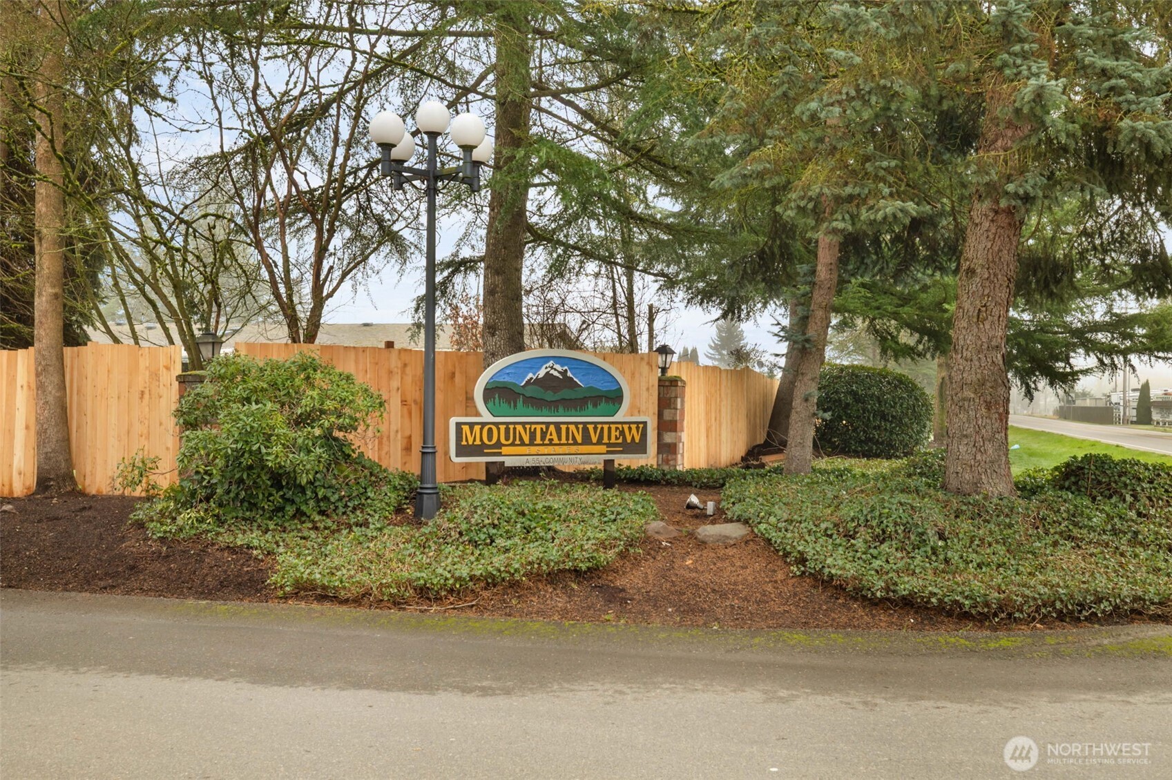 836 Harman Way South, Unit 33 Orting, WA 98360 - Photo 30 of 30 a backyard of a house with a garden and tree