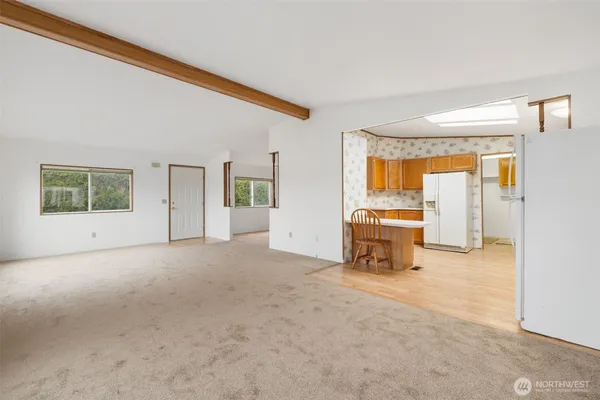 a view of a livingroom with furniture and an empty room
