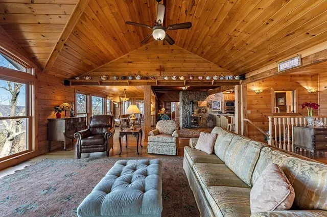 a view of a hallway with wooden floor and a fireplace