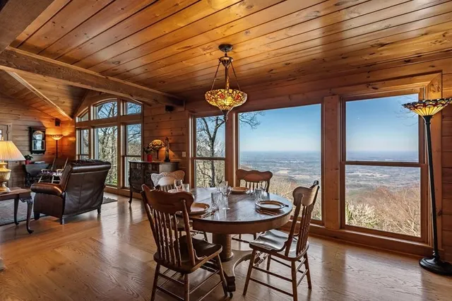 a living room with furniture a fireplace and a floor to ceiling window