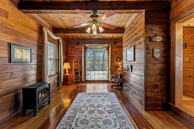 a room with lots of furniture and a potted plant