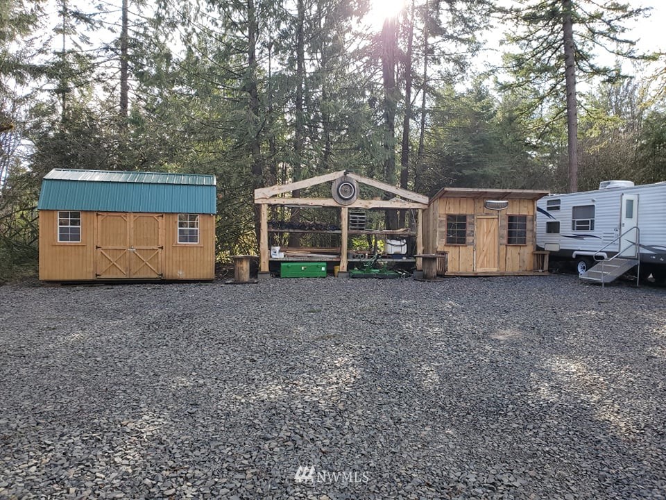 369 Hart Road, Unit 38 Winlock, WA 98596 - Photo 2 of 33 a view of a house with a yard and covered with tall trees