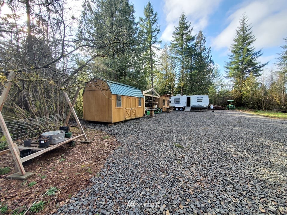 369 Hart Road, Unit 38 Winlock, WA 98596 - Photo 8 of 33 a backyard of a house with barbeque oven and wooden fence