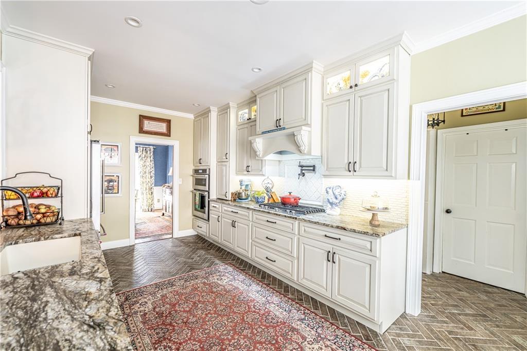 36 Saddle Mountain Road Southeast Rome, GA 30161 - Photo 11 of 42 a kitchen with stainless steel appliances kitchen island granite countertop a refrigerator and a sink