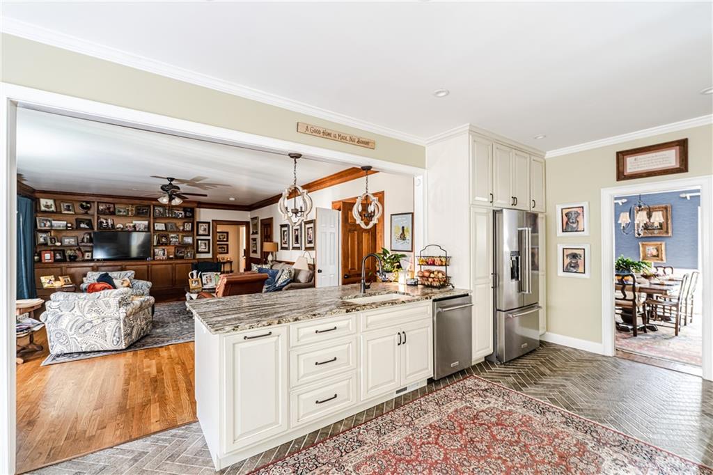 36 Saddle Mountain Road Southeast Rome, GA 30161 - Photo 12 of 42 a kitchen with stainless steel appliances kitchen island granite countertop a refrigerator a sink and white cabinets