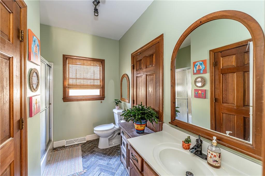 36 Saddle Mountain Road Southeast Rome, GA 30161 - Photo 24 of 42 a bathroom with a sink a mirror and a toilet