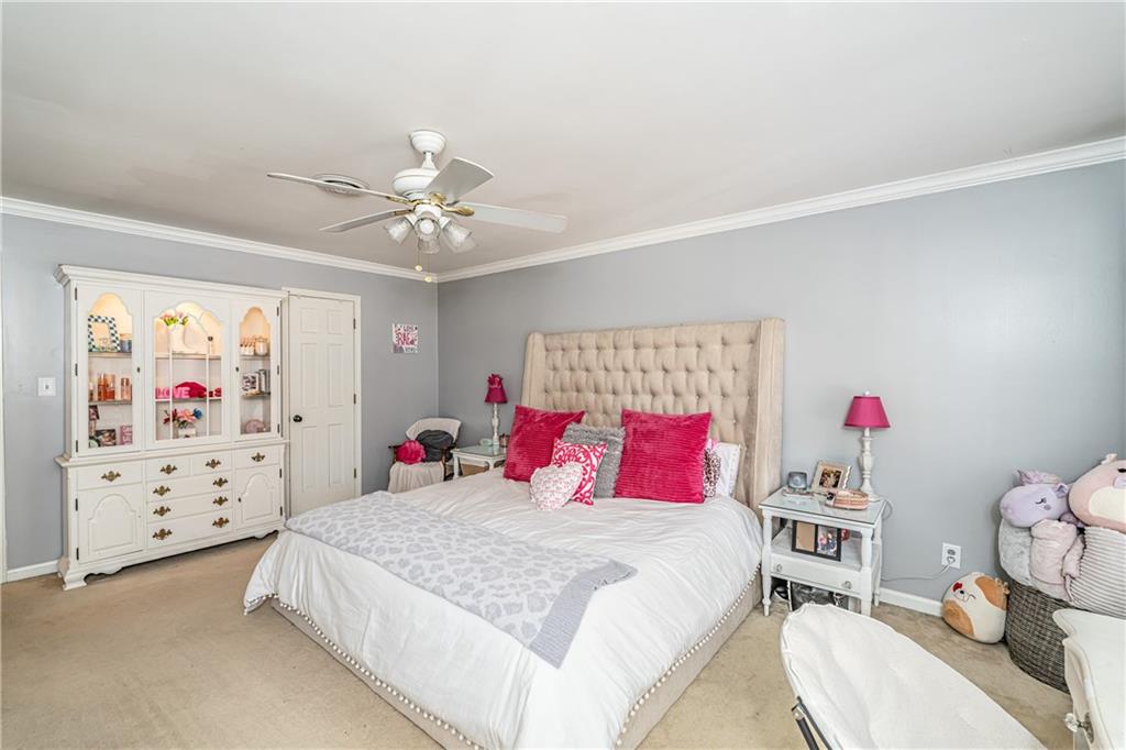 36 Saddle Mountain Road Southeast Rome, GA 30161 - Photo 28 of 42 a bedroom with a bed and a chandelier