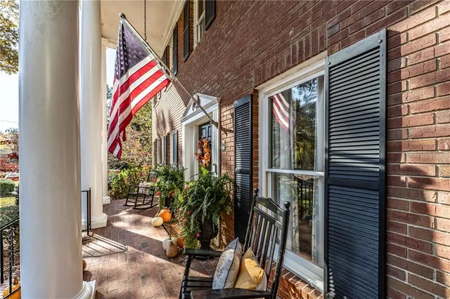 a living room with furniture and a flat screen tv with wooden floor