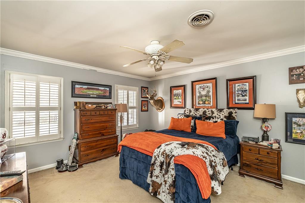 36 Saddle Mountain Road Southeast Rome, GA 30161 - Photo 31 of 42 a bedroom with a bed and wooden floor