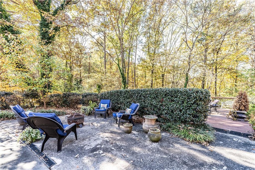 36 Saddle Mountain Road Southeast Rome, GA 30161 - Photo 39 of 42 a view of a patio with table and chairs potted plants and large tree