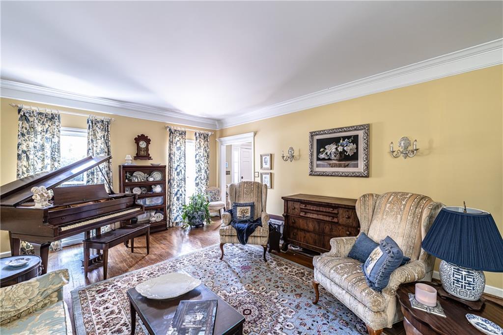 36 Saddle Mountain Road Southeast Rome, GA 30161 - Photo 4 of 42 a living room with furniture and a flat screen tv with wooden floor