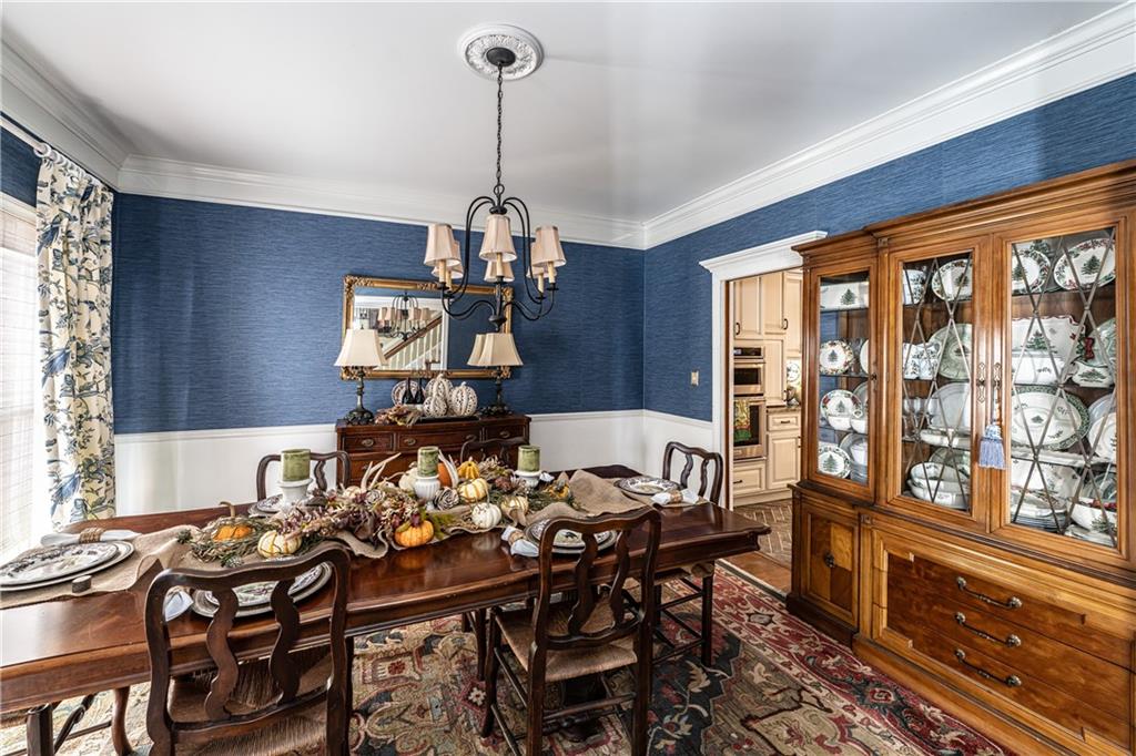 36 Saddle Mountain Road Southeast Rome, GA 30161 - Photo 8 of 42 a view of a dining room and livingroom with furniture wooden floor a chandelier