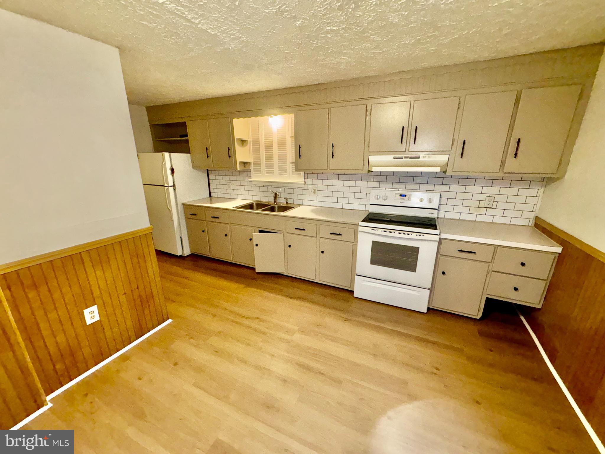 823 Scull Street Lebanon, PA 17046 - Photo 2 of 8 a kitchen with stainless steel appliances a stove a sink and white cabinets