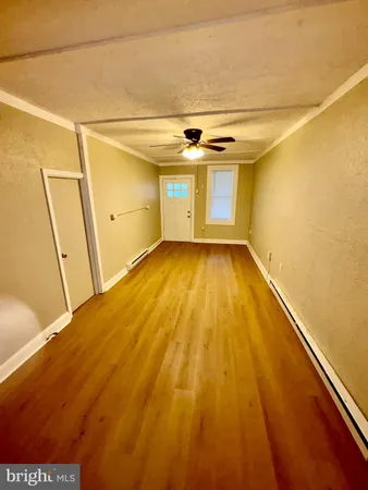 a view of a room with wooden floor