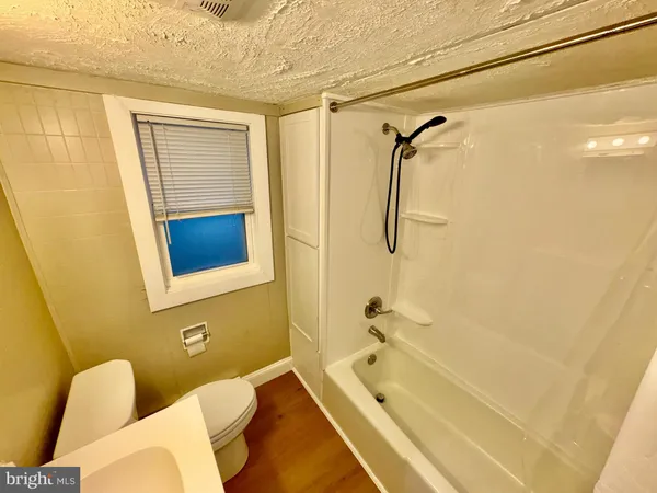a bathroom with a tub and a shower