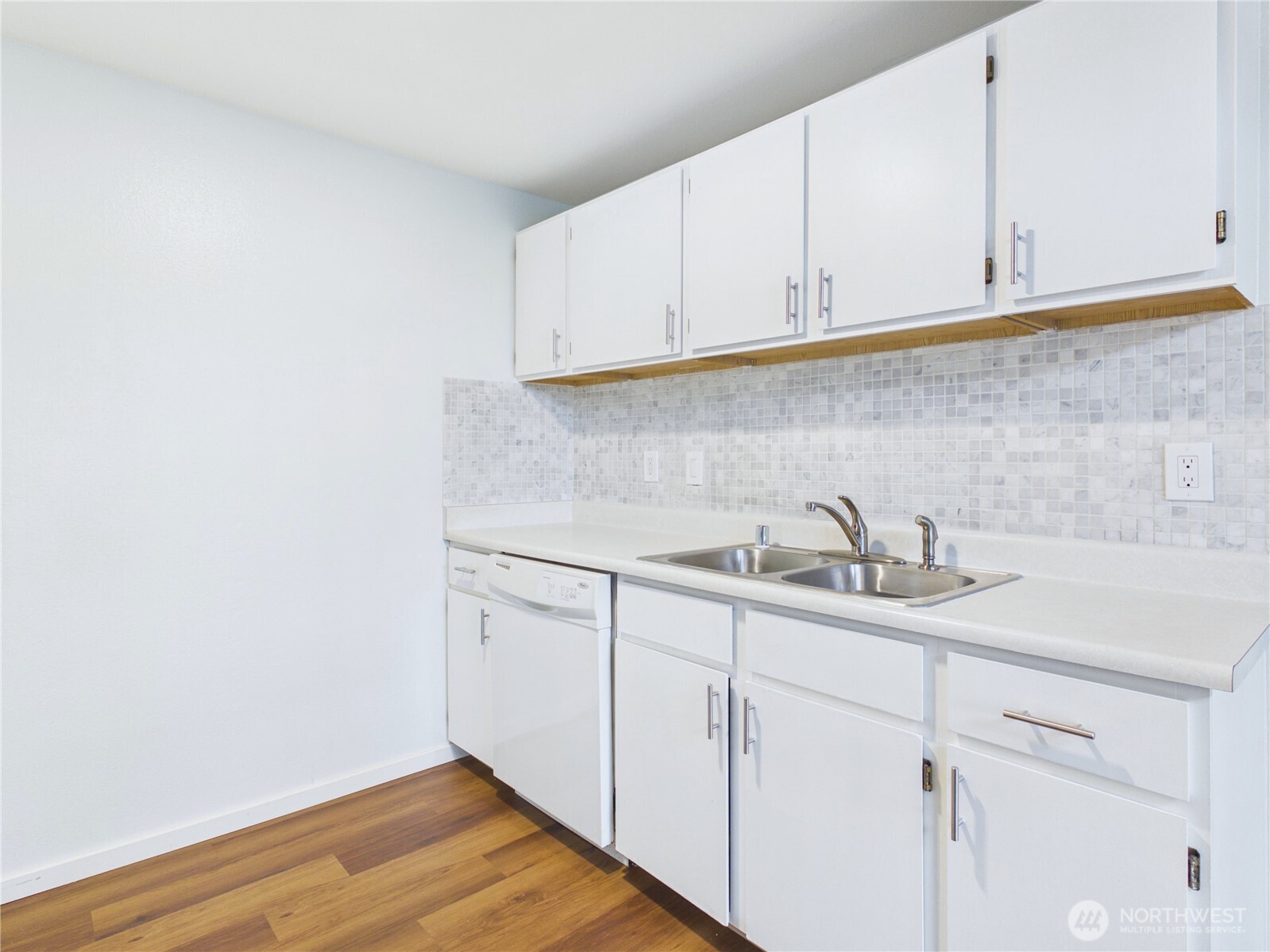 11002 Southeast Petrovitsky Road, Unit I102 Renton, WA 98055 - Photo 7 of 24 a kitchen with stainless steel appliances granite countertop white cabinets sink and dishwasher