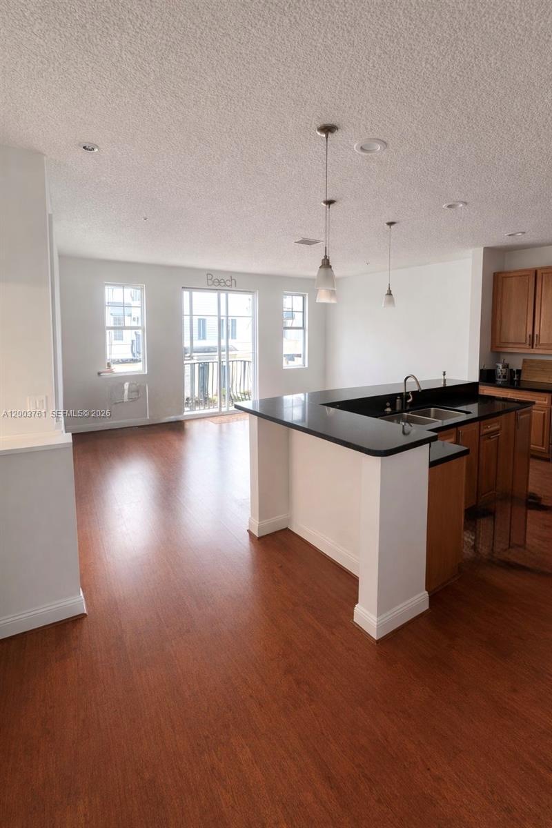 556 North West 39th Circle Boca Raton, FL 33431 - Photo 11 of 19 a kitchen with granite countertop a sink and a stove top oven