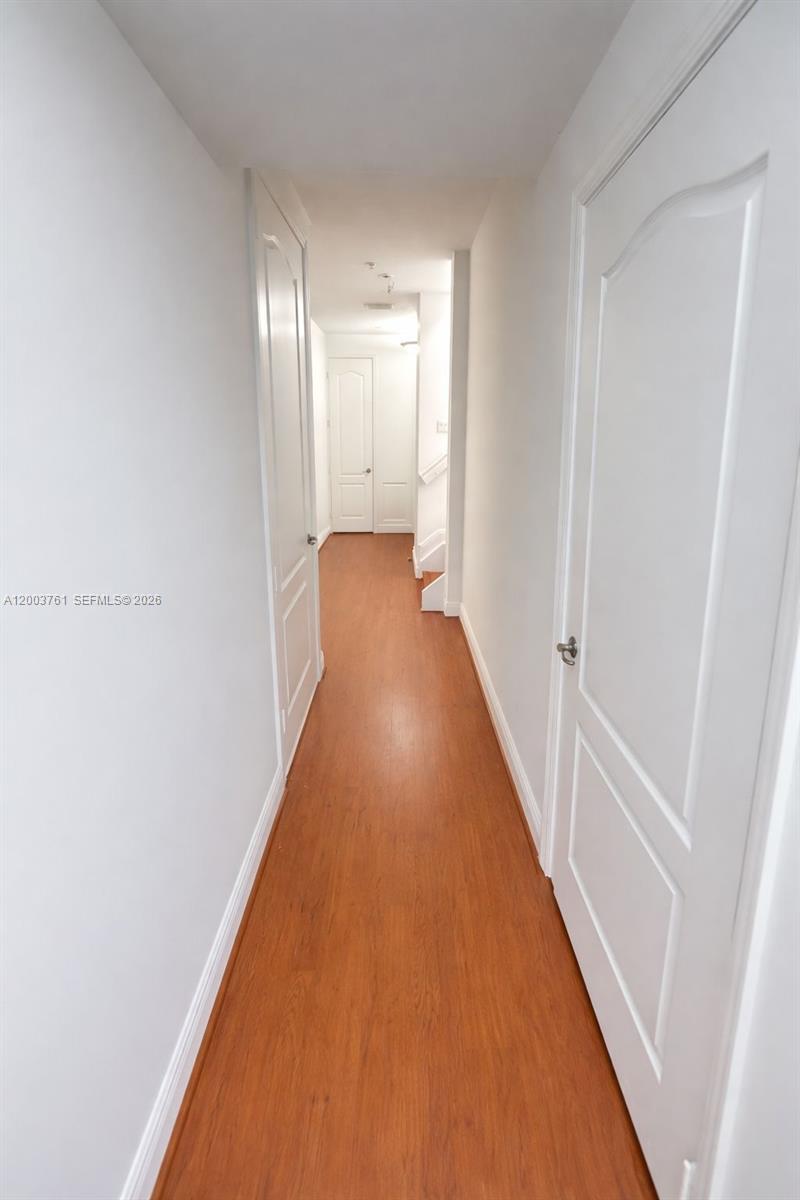 556 North West 39th Circle Boca Raton, FL 33431 - Photo 15 of 19 a view of a hallway with wooden floor