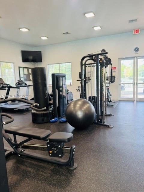 556 North West 39th Circle Boca Raton, FL 33431 - Photo 6 of 19 a room with gym equipment and a large mirror