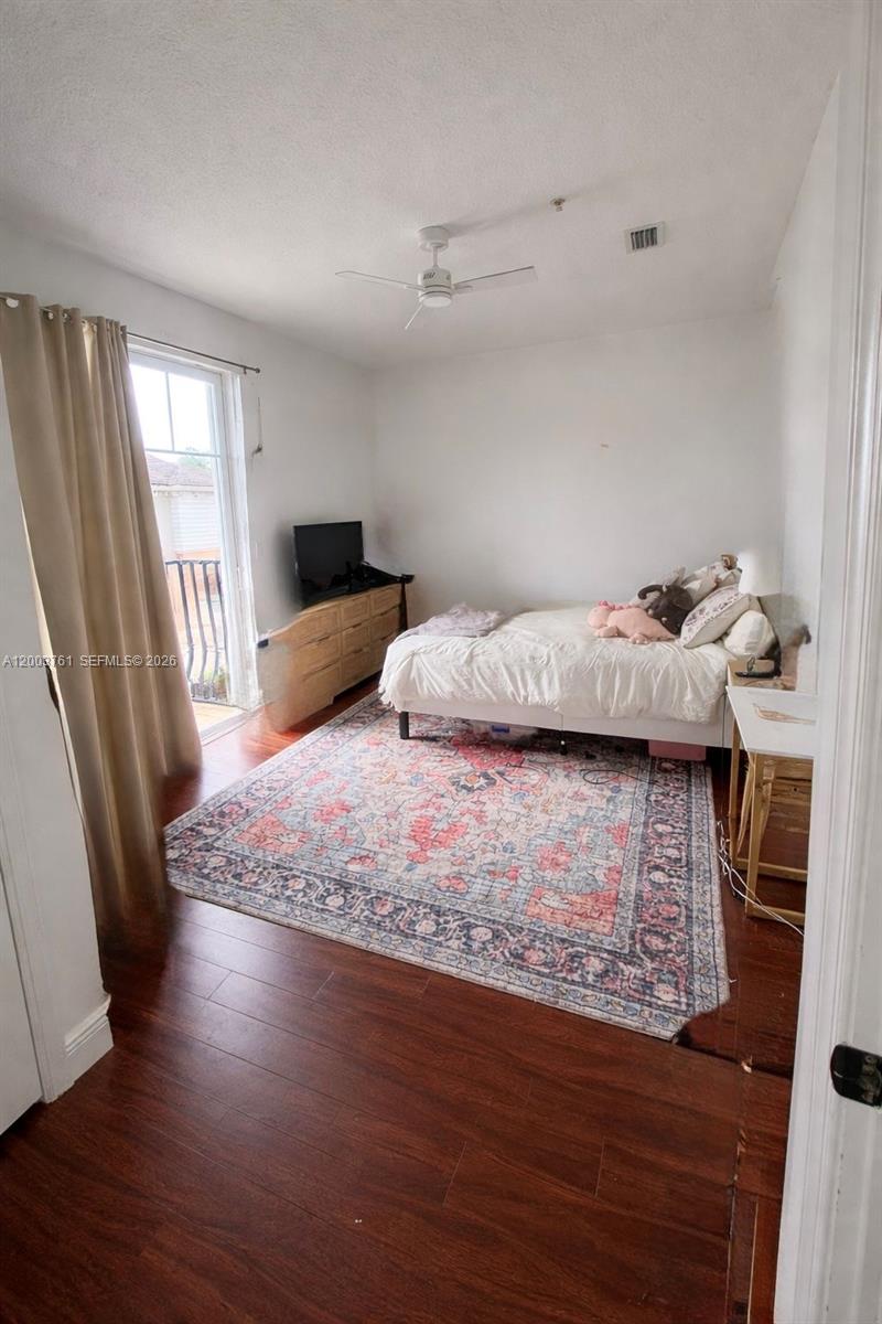 556 North West 39th Circle Boca Raton, FL 33431 - Photo 8 of 19 a bedroom with a bed and wooden floor
