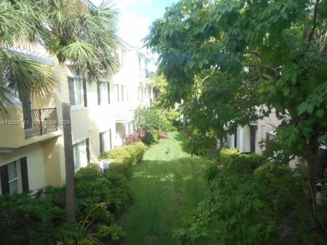 556 North West 39th Circle Boca Raton, FL 33431 - Photo 10 of 19 a view of a building with a garden