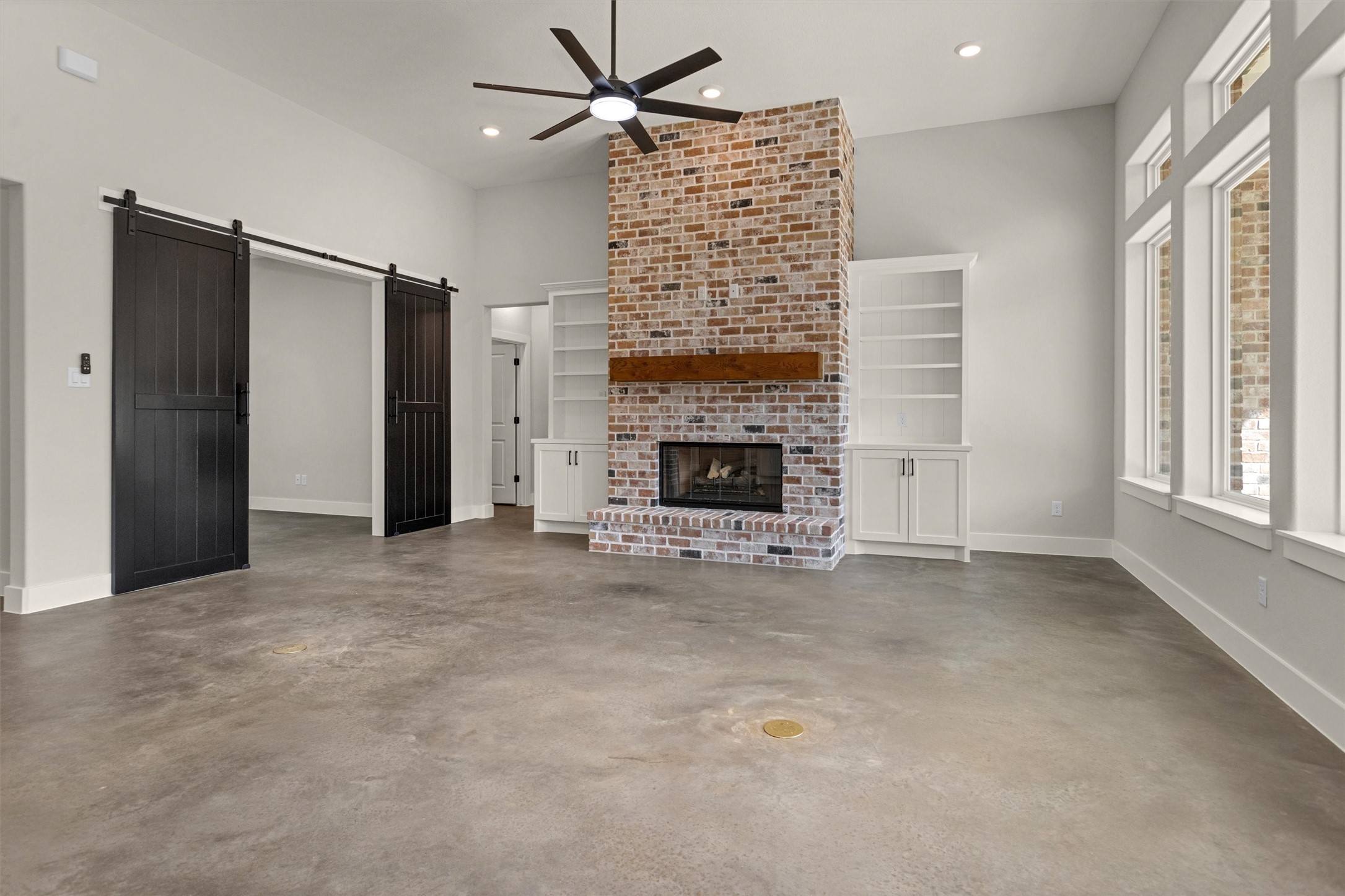 12744 Oak Barrel Road Willis, TX 77378 - Photo 8 of 50 The living area is a warm and inviting space designed for both comfort and connection. A stunning gas log fireplace, bricked from floor to ceiling, serves as a dramatic focal point — adding texture, height, and timeless character to the room.