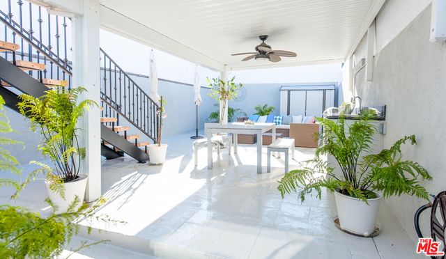 a view of a dining room with furniture a potted plant and a chandelier