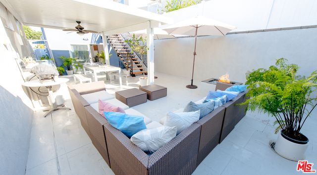 a living room with furniture potted plant and a large mirror