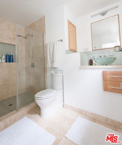 a bathroom with a toilet sink and shower