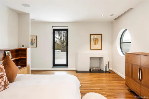 a view of an empty room with window and cabinet