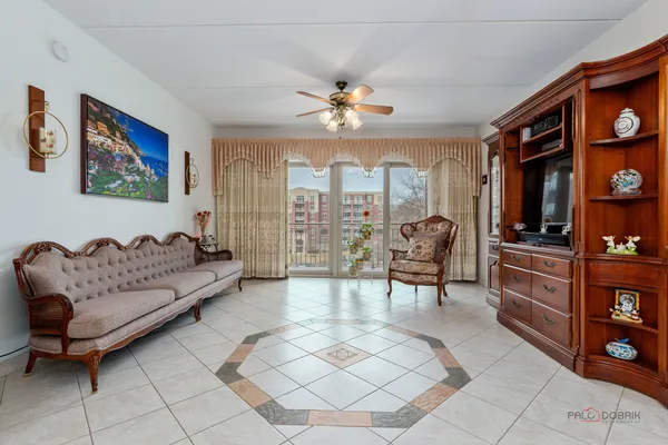 a living room with furniture a chandelier and a flat screen tv