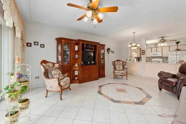 a living room with furniture and a chandelier