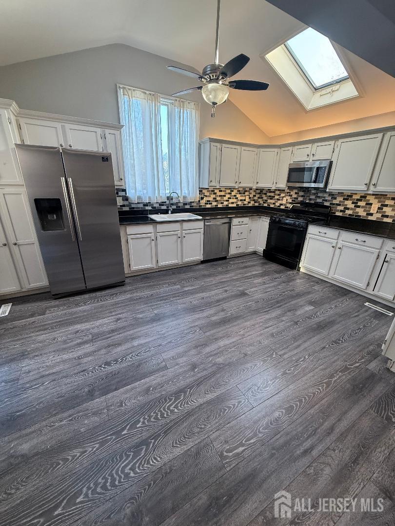 4 Davids Lane Howell, NJ 07731 - Photo 13 of 21 a kitchen with granite countertop a stove a sink and a refrigerator