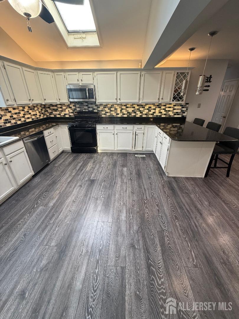4 Davids Lane Howell, NJ 07731 - Photo 15 of 21 a kitchen with stainless steel appliances granite countertop a stove and cabinets