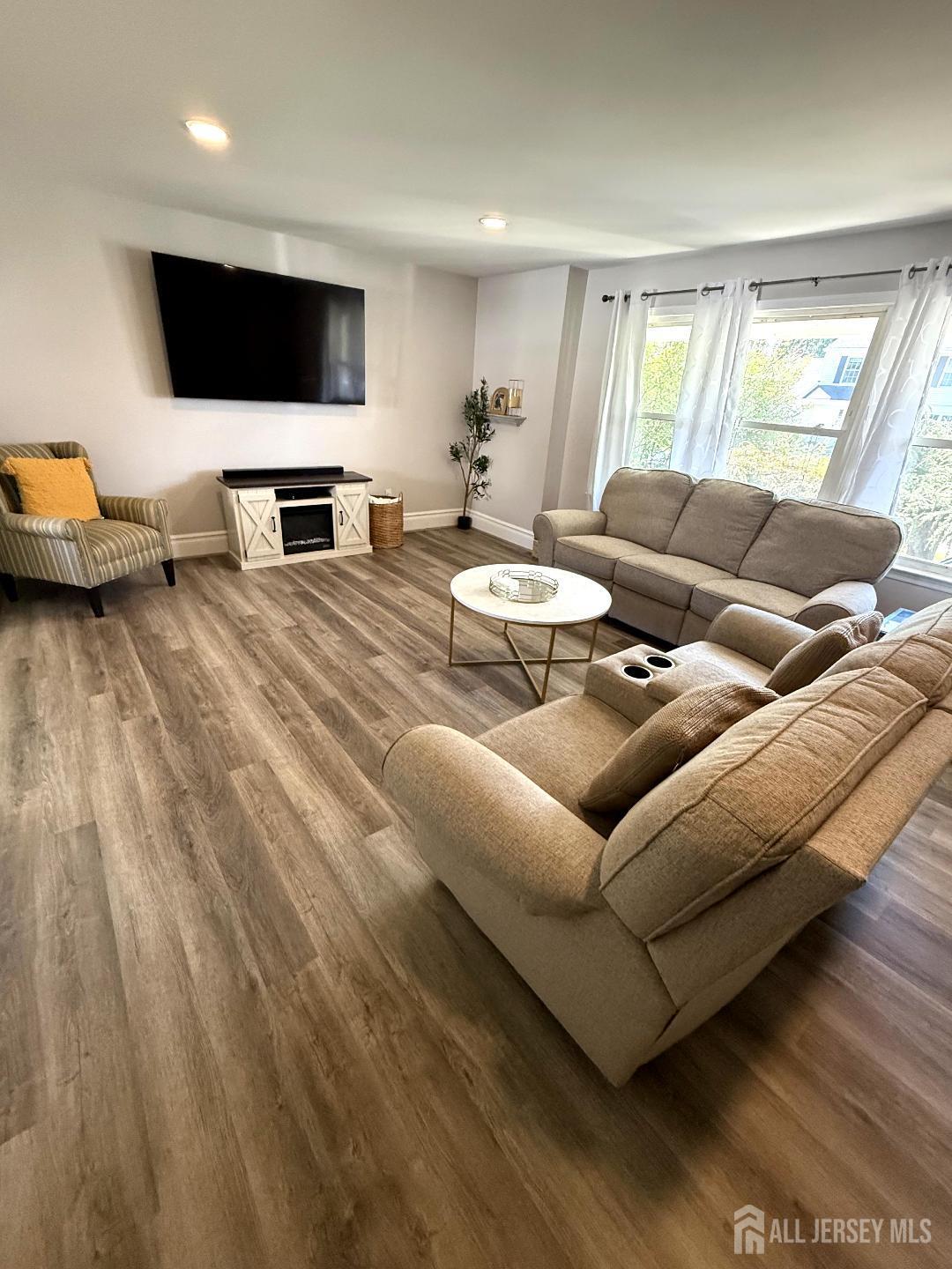 4 Davids Lane Howell, NJ 07731 - Photo 6 of 21 a living room with furniture and a flat screen tv