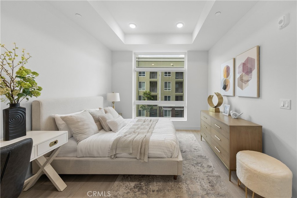 168 South Monterey Street, Unit 410 Alhambra, CA 91801 - Photo 22 of 27 a bedroom with a bed and a potted plant