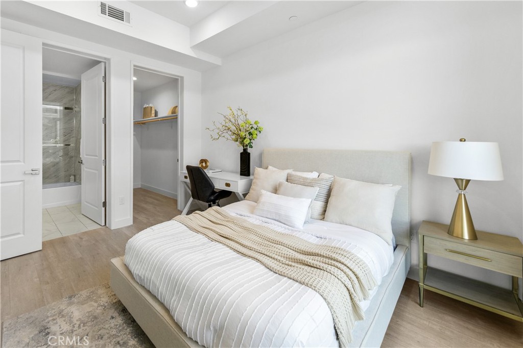 168 South Monterey Street, Unit 410 Alhambra, CA 91801 - Photo 25 of 27 a bedroom with a bed and a lamp