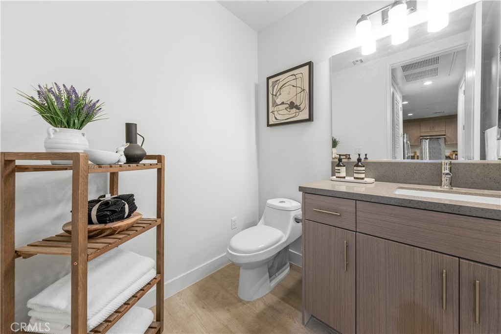 168 South Monterey Street, Unit 410 Alhambra, CA 91801 - Photo 7 of 27 a bathroom with a sink a toilet and a mirror