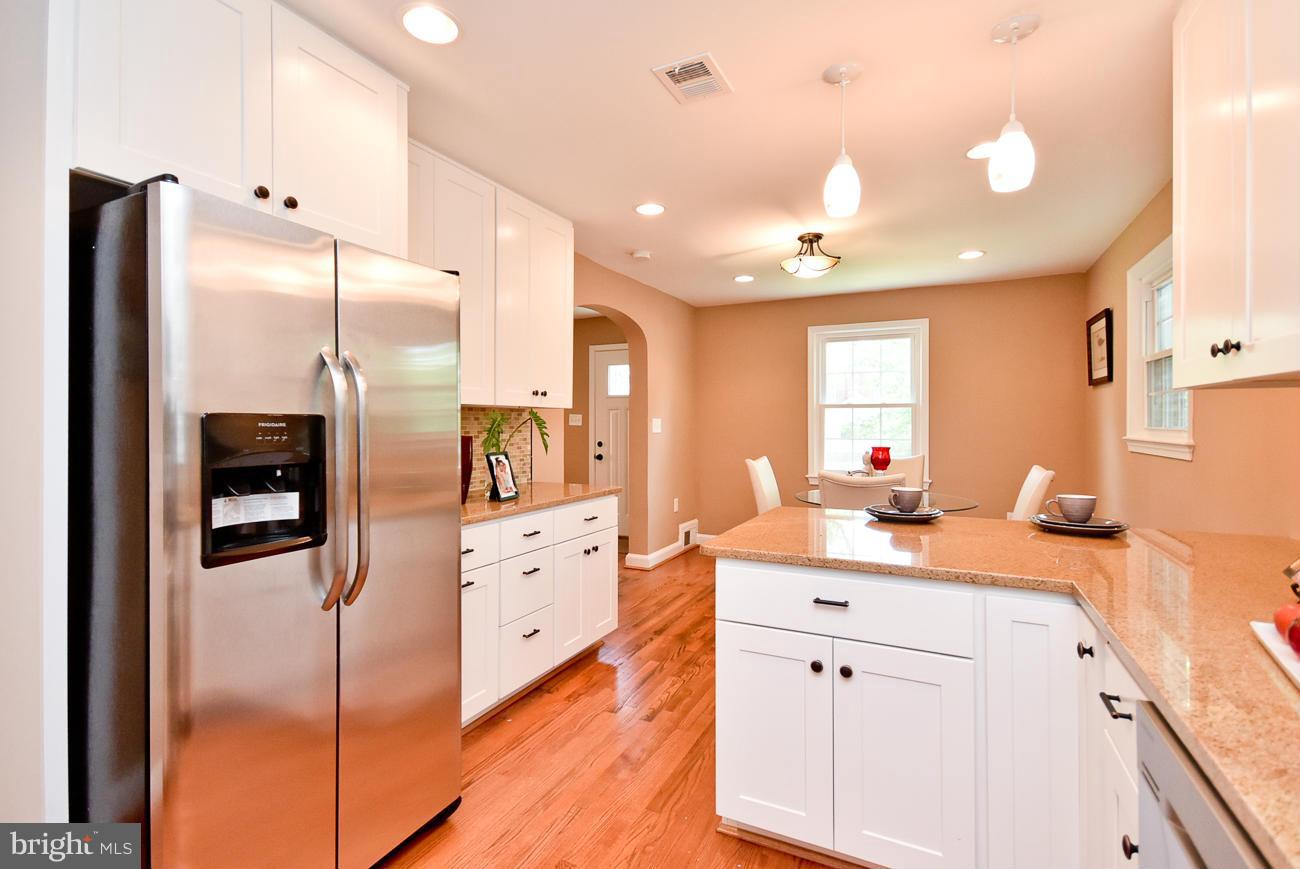 5900 Grayson Street Springfield, VA 22150 - Photo 11 of 30 a large kitchen with stainless steel appliances kitchen island granite countertop a refrigerator and a sink