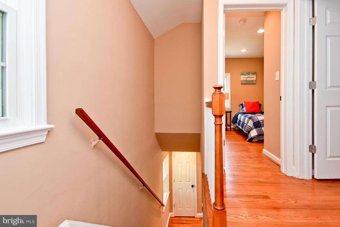 5900 Grayson Street Springfield, VA 22150 - Photo 14 of 30 a hallway with wooden floor and furniture