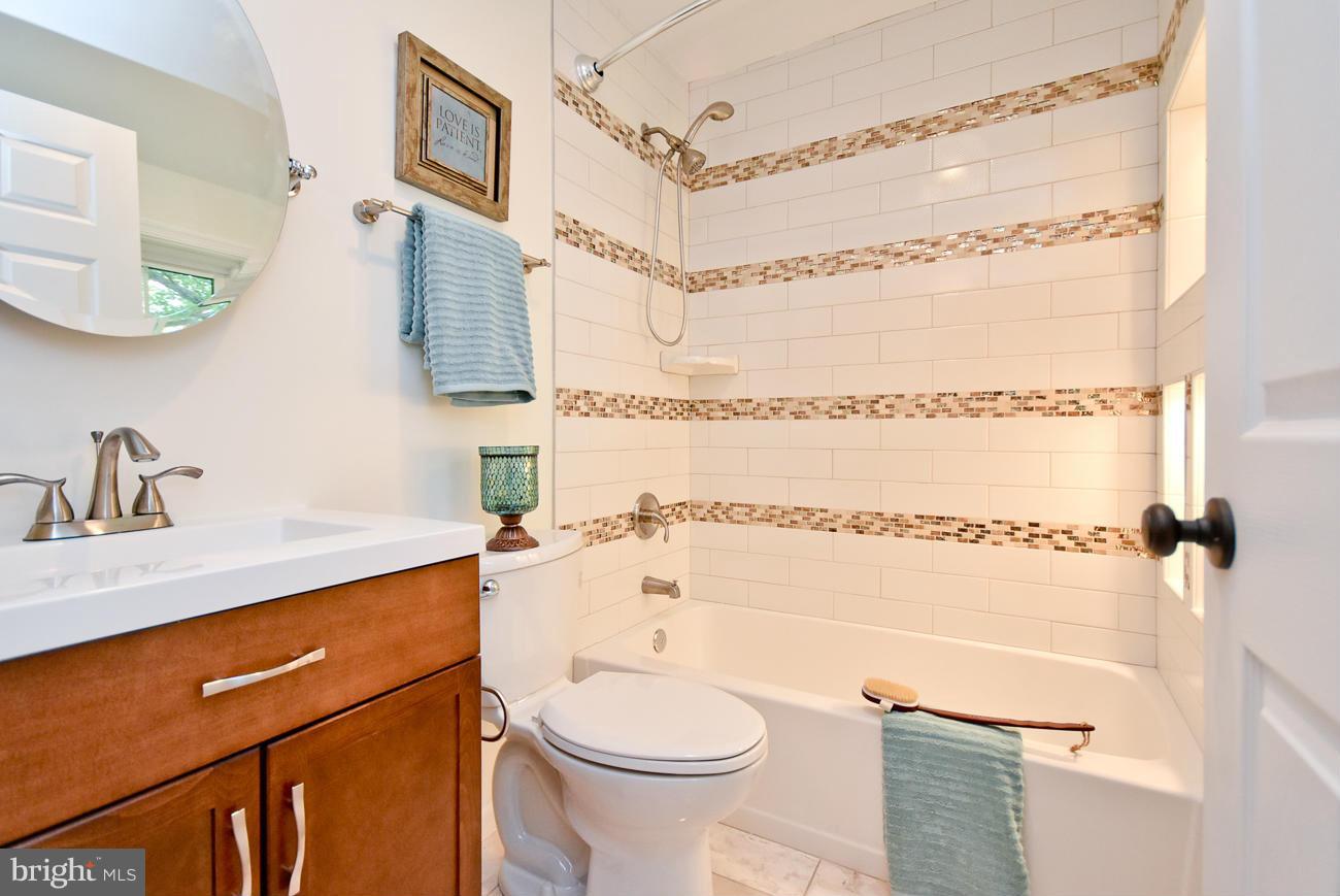 5900 Grayson Street Springfield, VA 22150 - Photo 16 of 30 a bathroom with a sink a toilet and shower