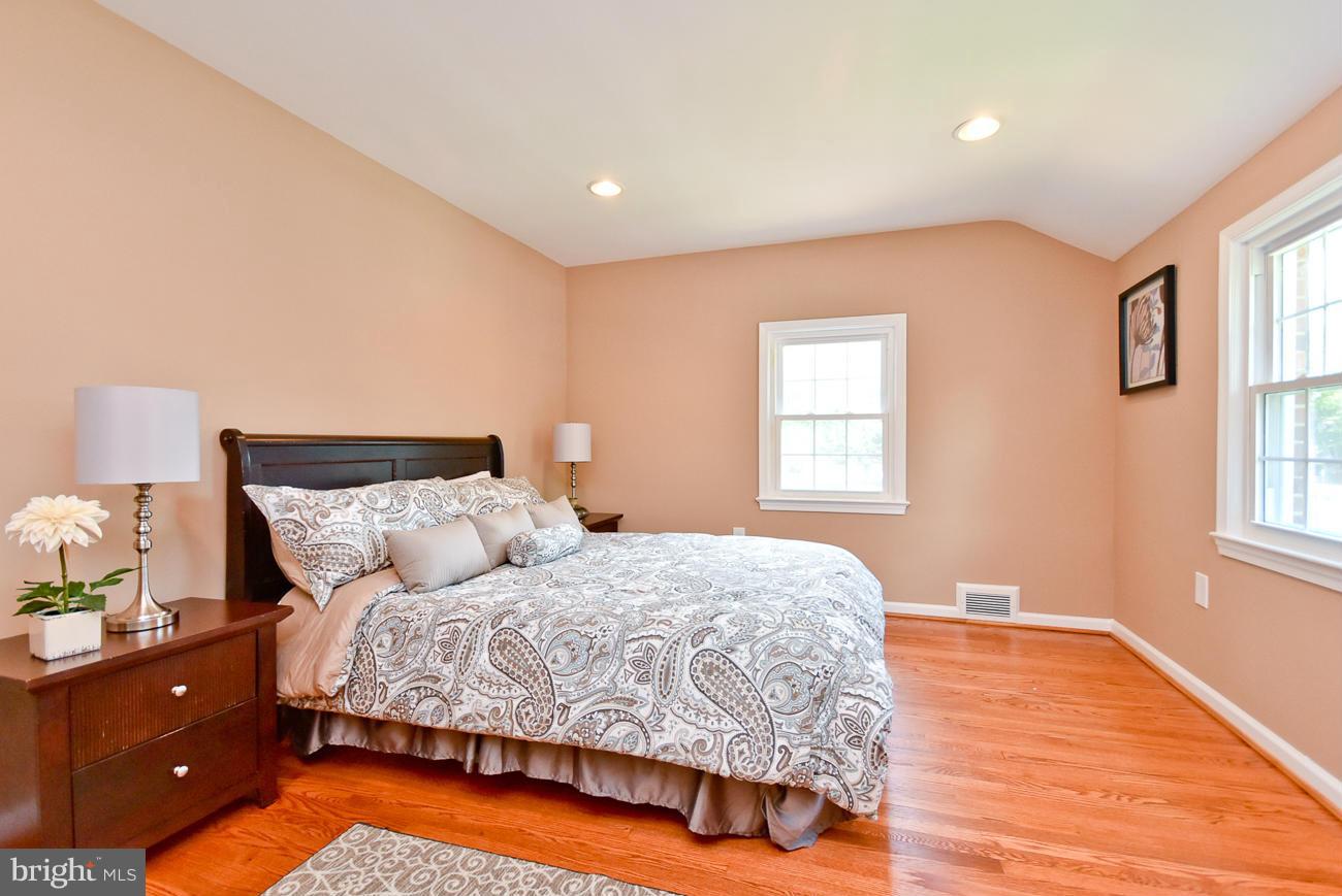 5900 Grayson Street Springfield, VA 22150 - Photo 18 of 30 a bedroom with a bed and wooden floor