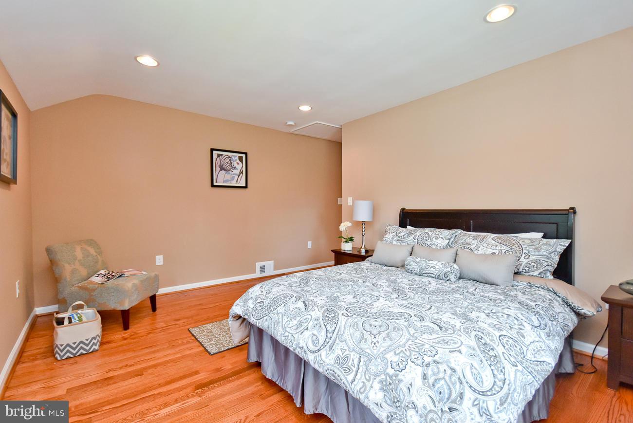 5900 Grayson Street Springfield, VA 22150 - Photo 19 of 30 a bedroom with a bed and wooden floor
