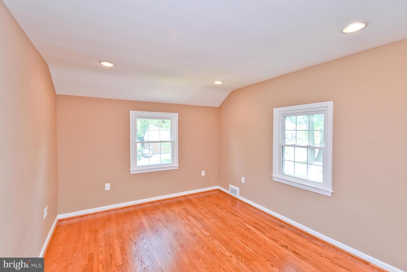 5900 Grayson Street Springfield, VA 22150 - Photo 20 of 30 an empty room with wooden floor and windows