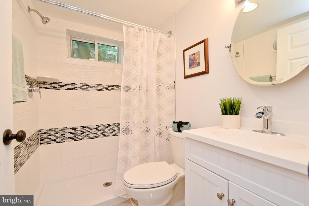 5900 Grayson Street Springfield, VA 22150 - Photo 24 of 30 a bathroom with a sink a toilet and shower