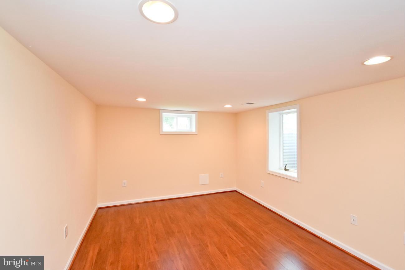 5900 Grayson Street Springfield, VA 22150 - Photo 25 of 30 a view of an empty room with wooden floor and a window